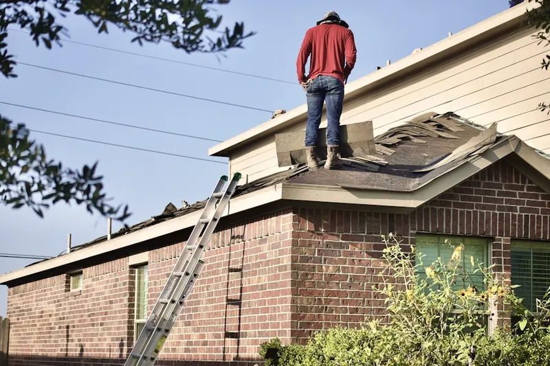 Professional roofer working on a residential roof in Lyncourt